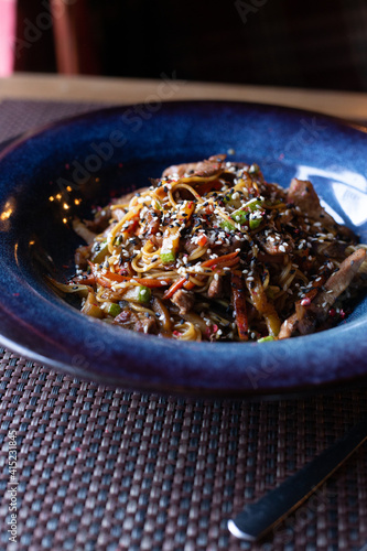 Wok on a blue platter