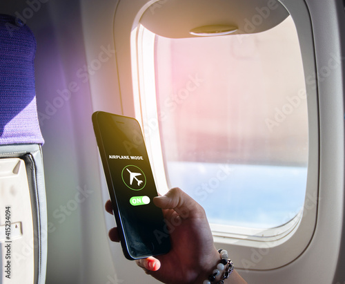 Flight mode concept Slide your finger on the screen to turn on Airplane mode, cut off the smartphone communication near the window on the plane. For the safety of the trip