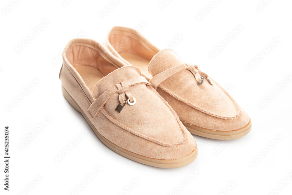 Pair of beige modern unisex loafers on white background Pair of beige modern unisex loafers on white background