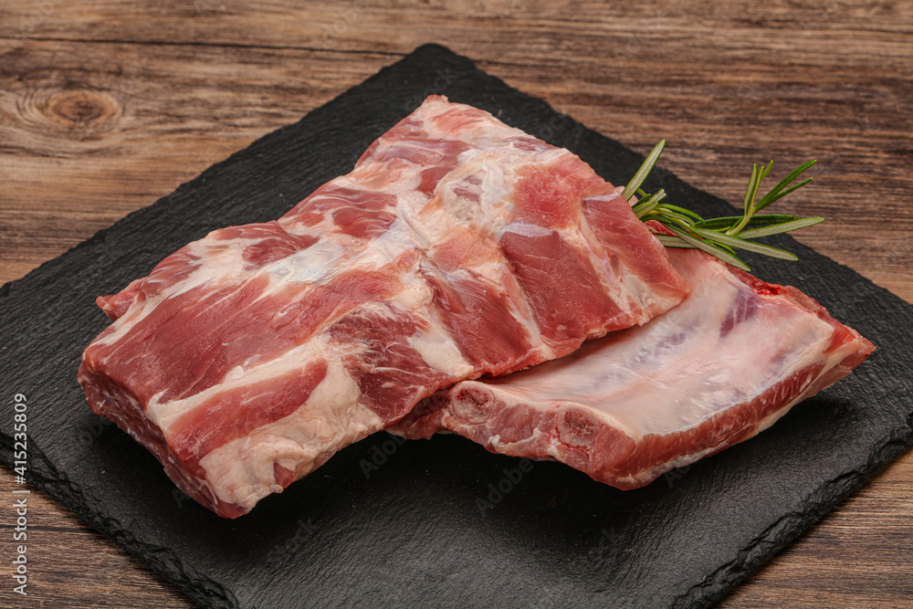 Raw pork ribs served rosemary Raw pork ribs served rosemary