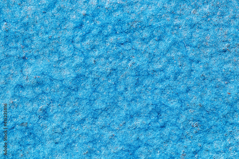 Rough metal surface painted in a light blue metallic color Rough metal surface painted in a light blue metallic color
