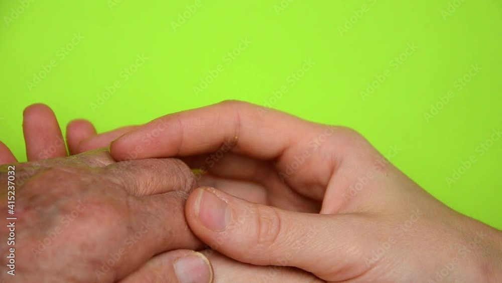 Old and young hands are held together. Friendly family concept. Cohesion. The concept of trust. Women's Day. Close-up of wrinkled hands. Thanks to the parents. Respect for old people Old and young hands are held together. Friendly family concept. Cohesion. The concept of trust. Women's Day. Close-up of wrinkled hands. Thanks to the parents. Respect for old people