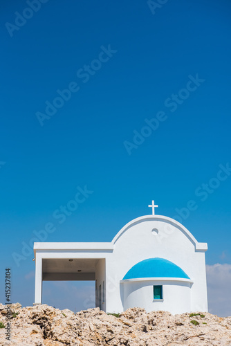 Traditional white chapel with a blue roof on the seaside. Agioi Anargyroi, Cyprus