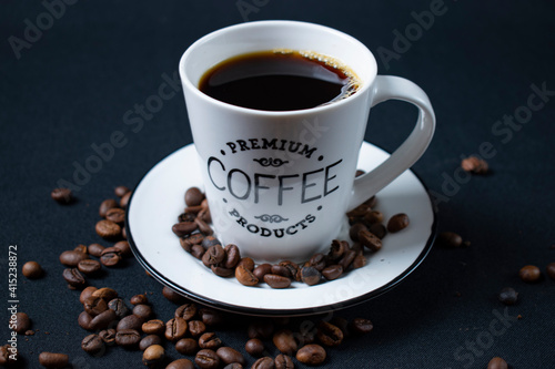 white coffee cup with coffee and beans