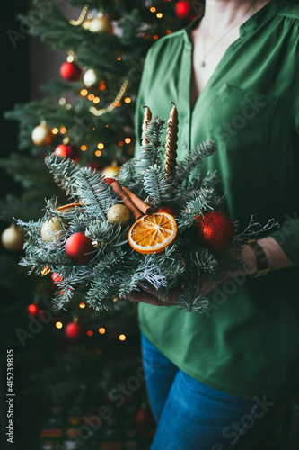 Christmas composition of fir tree, oranges, candles, cinnamon and balls