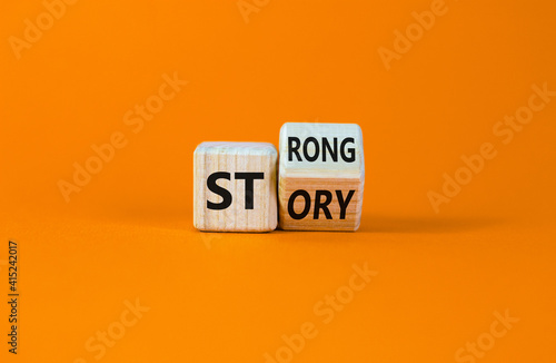 Strong story symbol. Turned wooden cubes with words 'strong story'. Beautiful orange background, copy space. Business and strong story concept.