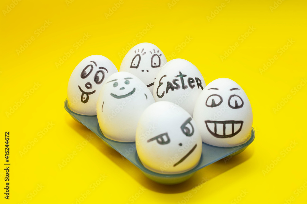 Easter eggs on a yellow background. Funny faces on eggs Easter eggs on a yellow background. Funny faces on eggs
