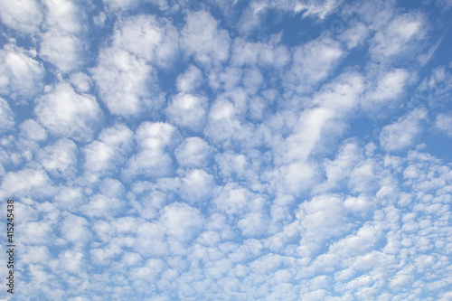 A view of the blue sky featuring clouds in a spotted design.