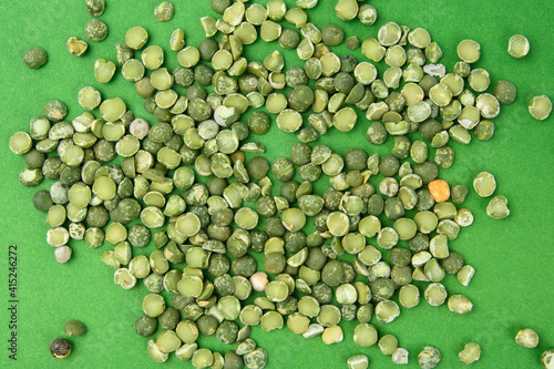 dried green peas photographed against a green background