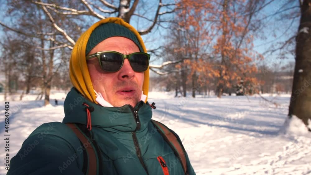 Rest while traveling in winter, recuperation. The movement of the camera in a circle. A man puts on sunglasses from the sun. Focus on the forest. Rest while traveling in winter, recuperation. The movement of the camera in a circle. A man puts on sunglasses from the sun. Focus on the forest.