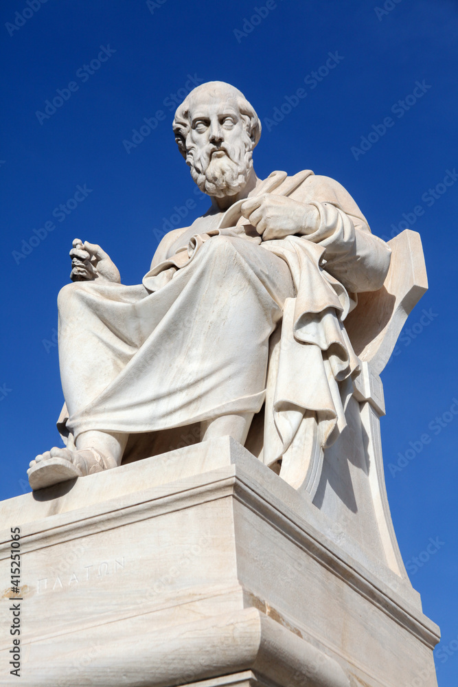 the marble statue of the ancient Greek philosopher Plato in front of National Academy of Athens. sunny day with blue sky