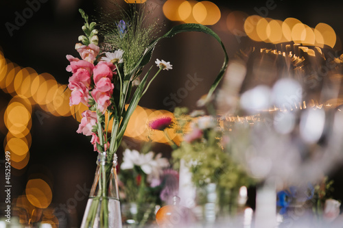 a flower vase on a table in a restaurant