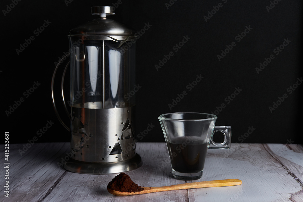 Coffee pot, cup and wooden spoon with coffee Coffee pot, cup and wooden spoon with coffee