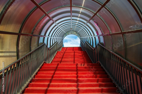 Red staircase with arched roof. Ascending forward to the sky