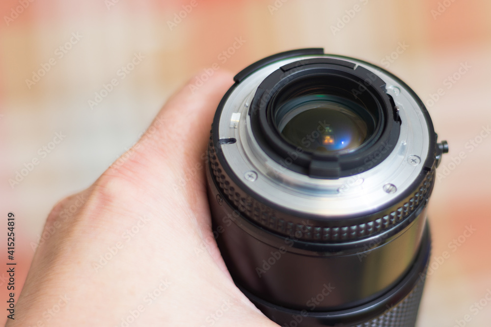 Photo of a lens for a camera. The background is blurred. Shallow depth of field