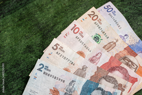 Colombian money on a textured green background 