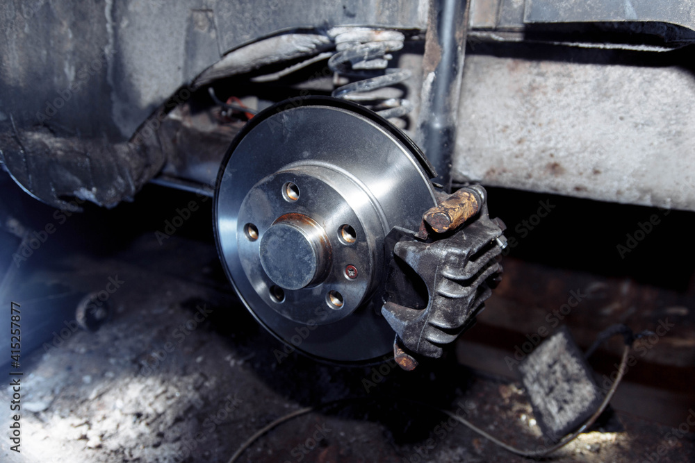 Fototapeta premium car brake system repair, brake disc replacement