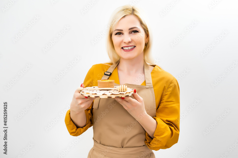 smiling young woman with bowl of honey on white background smiling young woman with bowl of honey on white background
