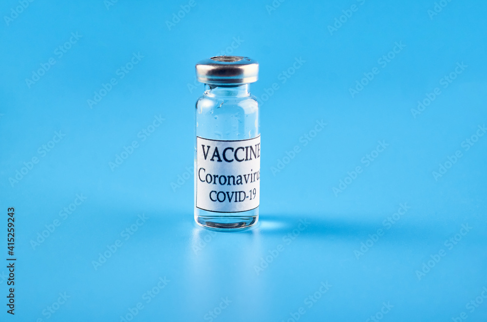 Coronavirus vaccine: a bottle on a blue background. The concept of immunization and vaccination. Copyspace. Coronavirus vaccine: a bottle on a blue background. The concept of immunization and vaccination. Copyspace.