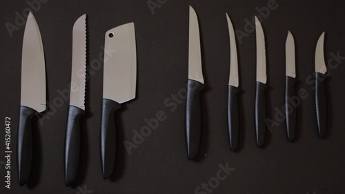 Wallpaper Mural Choosing a kitchen knife on black background seamless looping hand picking knife Torontodigital.ca