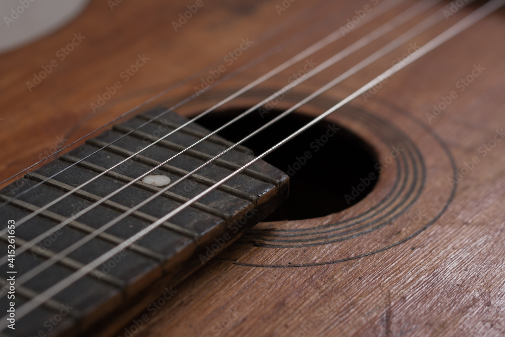Fototapeta premium close up photo of an old guitar. Macro photo of guitar strings.