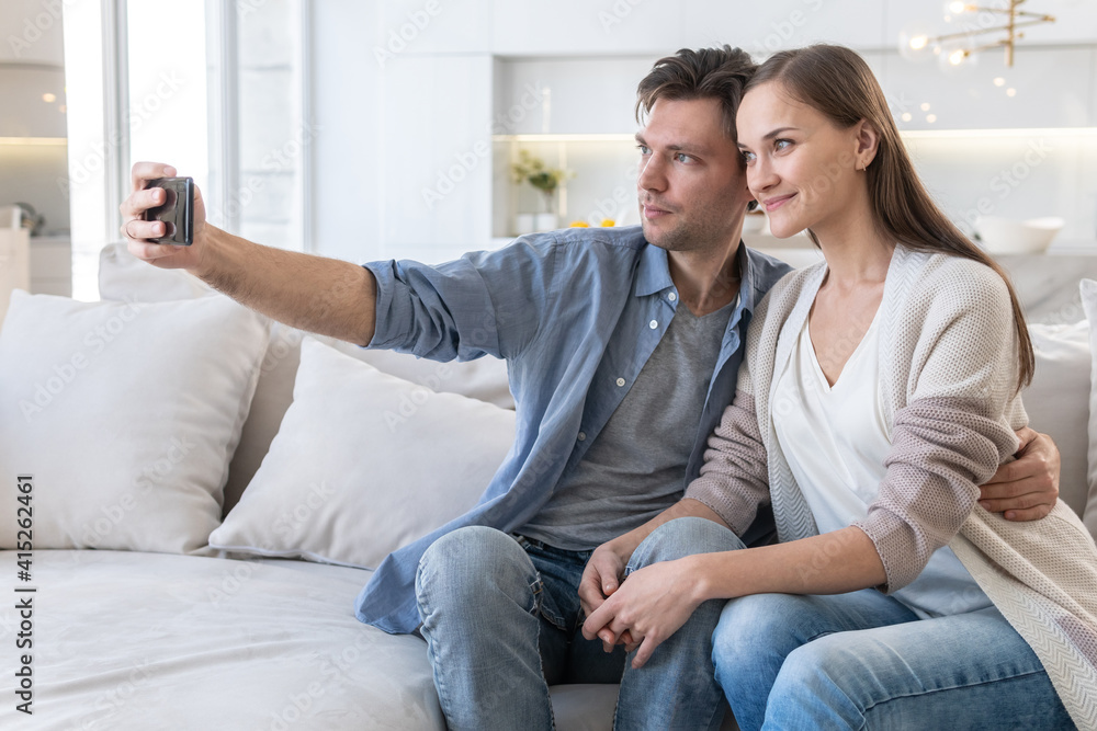 Cheerful couple looking at the smartphone screen Cheerful couple looking at the smartphone screen