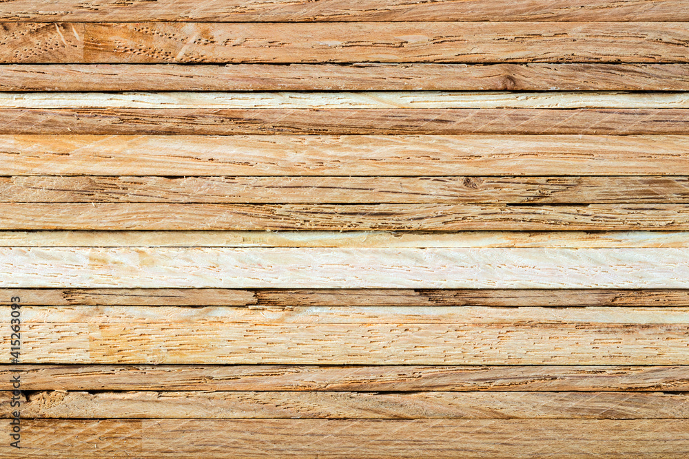 Obraz premium Close-up of a stack of oak strips. The horizontaly layered textured surface can serve as a background image.