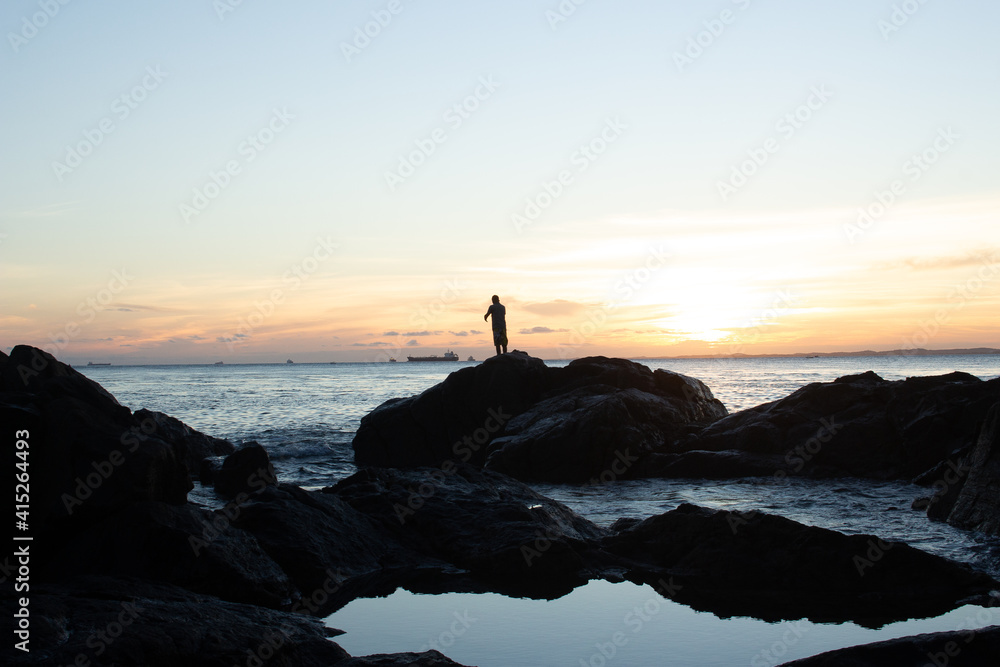  a man enjoying a sunset close the beach