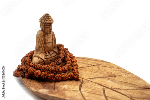 Buddha, lotus, wood carving, wooden buddha, incense stand and mala rosary made from rudraksha seeds photo