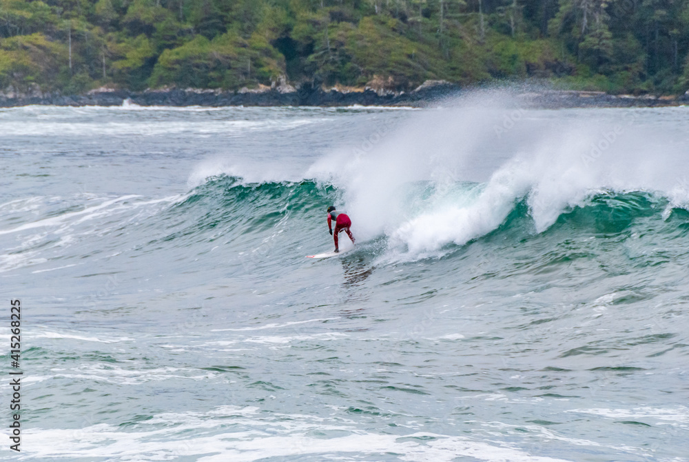 Surfer on Board at Stormy Waves of Beautiful Rocky Coast. Surfer on Board at Stormy Waves of Beautiful Rocky Coast.