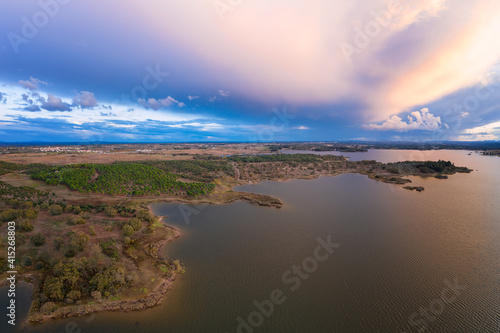 Lake drone aerial view of mountain panorama landscape at sunset in Marateca Dam in Castelo Branco, Portugal photo