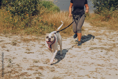 Tableau sur toile woman running pulled by a dog