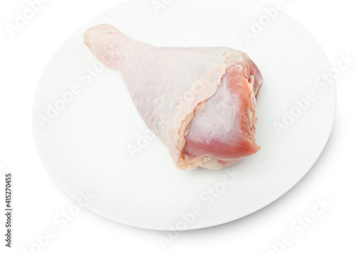 One RAW turkey leg on a white plate