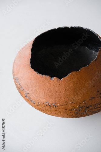 Big decorative clay mold in orange color on a white table