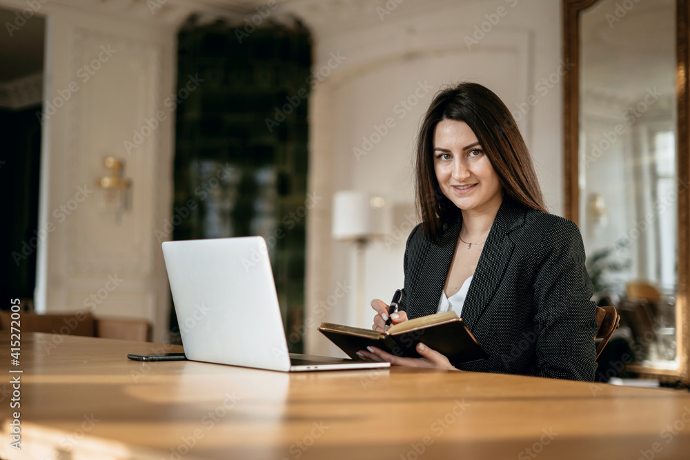 a financier is a business woman working on a computer. opens the laptop and prints the password. the lawyer in the company for Finance in the Bank. Modern office a financier is a business woman working on a computer. opens the laptop and prints the password. the lawyer in the company for Finance in the Bank. Modern office