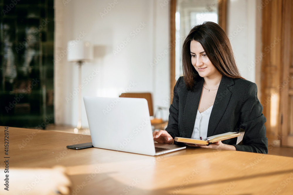 a financier is a business woman working on a computer. opens the laptop and prints a message to colleagues. the lawyer in the company for Finance in the Bank. Modern office a financier is a business woman working on a computer. opens the laptop and prints a message to colleagues. the lawyer in the company for Finance in the Bank. Modern office