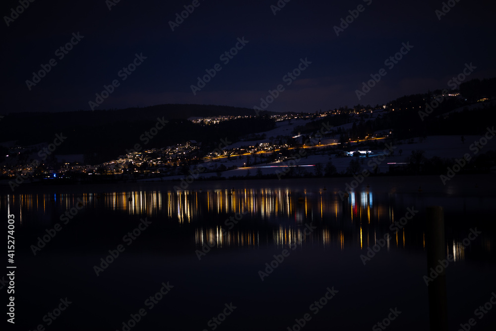 Swiss lake and lights in the middle of the freezing night