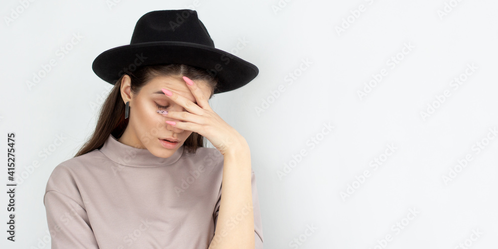 Portrait of annoyed stylish European girl making face palm gesture, feeling bored while talking to her friend who speaking nonstop. Body language Portrait of annoyed stylish European girl making face palm gesture, feeling bored while talking to her friend who speaking nonstop. Body language