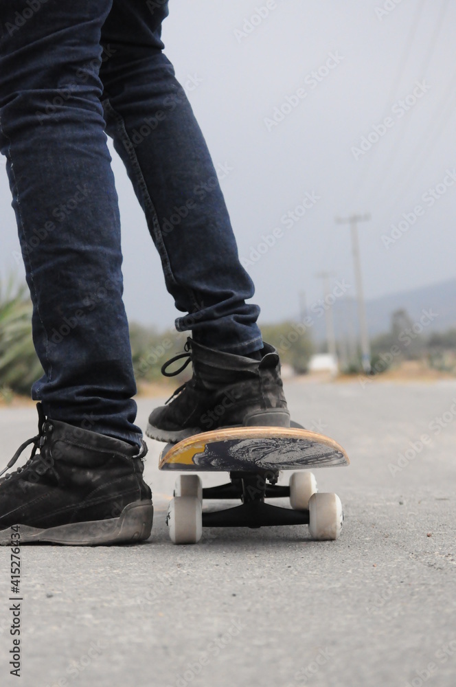 young man practicing sport with a skateboard in the street young man practicing sport with a skateboard in the street