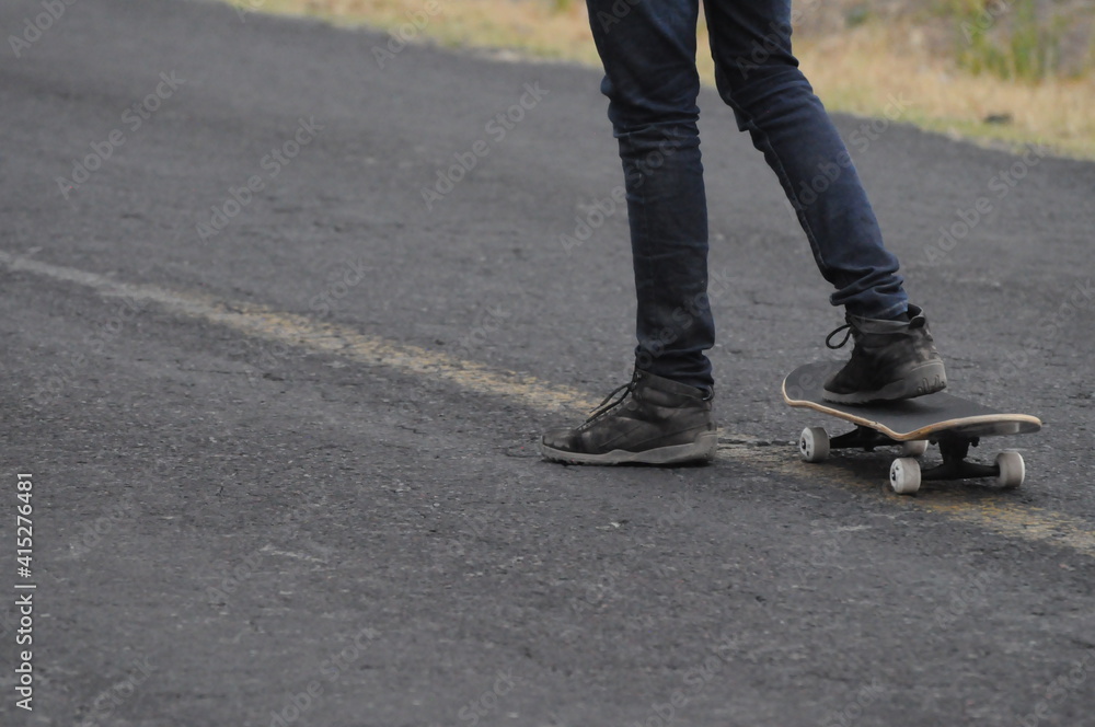 young man practicing sport with a skateboard in the street young man practicing sport with a skateboard in the street