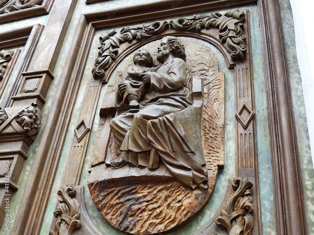 Сlose up of entrance carved wooden door of church DE LA MERCED in Cuenca city, Ecuador. Church built between 1887 and 1918.