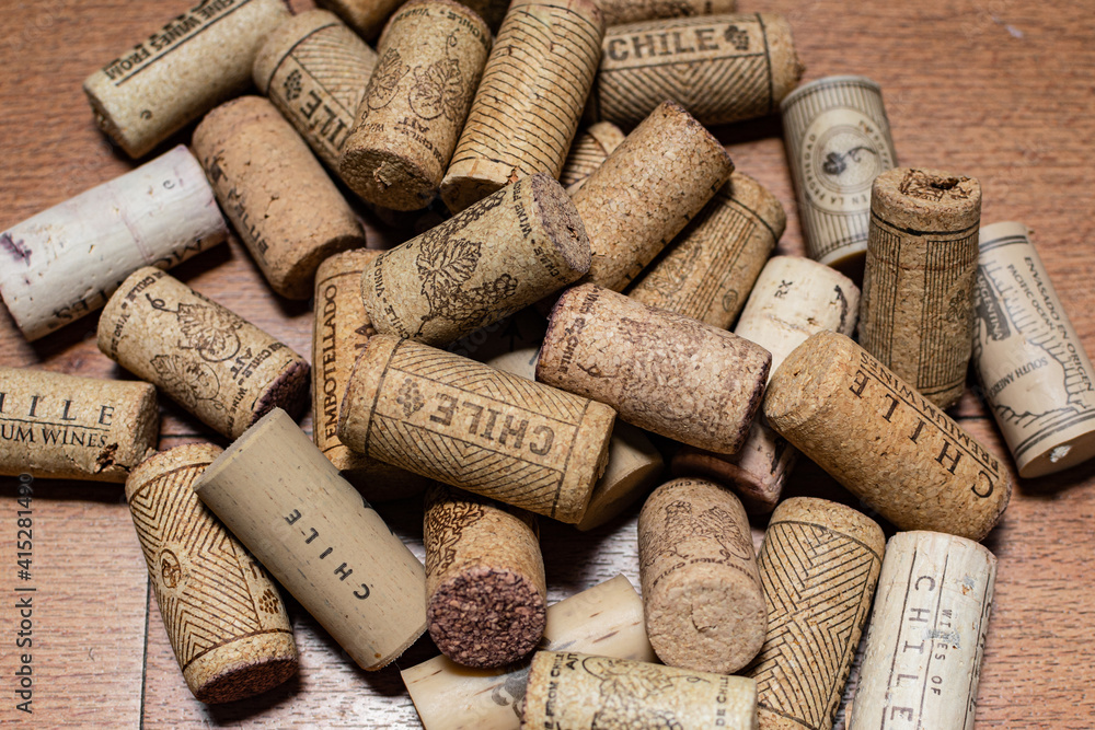 Bunch of wine corks over a white blanket

