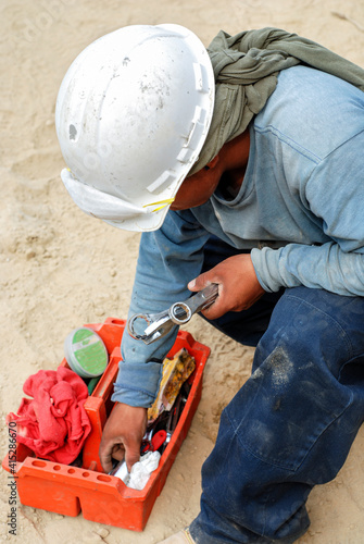 Worker looking through his toolbox