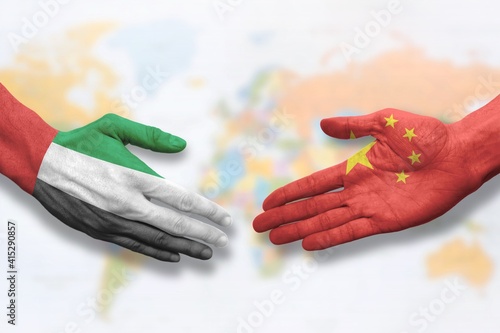 United Arab Emirates and China - Flag handshake symbolizing partnership and cooperation photo