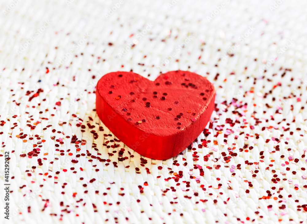 red wooden love heart with red glitter. concept of happiness