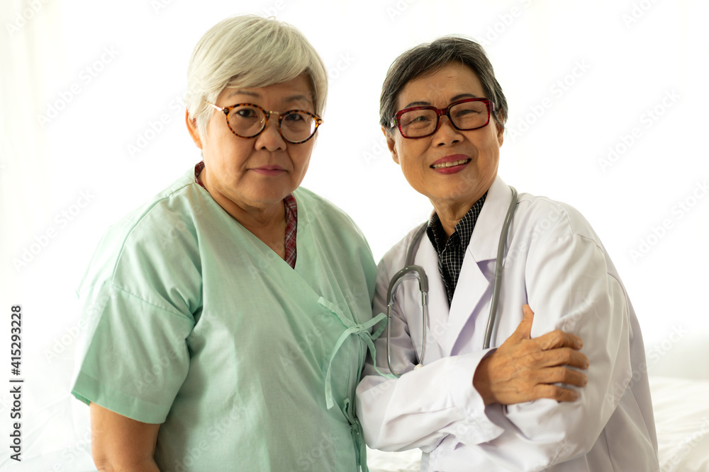 Portrait of woman senior doctor consulting and senior woman patient with stethoscope looking at camera in hospital.healthcare and medicine Portrait of woman senior doctor consulting and senior woman patient with stethoscope looking at camera in hospital.healthcare and medicine