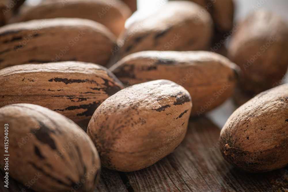 Pecan Nuts In Shell On Wood Table Pecan Nuts In Shell On Wood Table