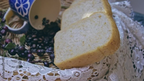 Wicker basket With lace Cup  blue and Whole wheat bread  coffee beans with sun light 4K technique slide moving control.