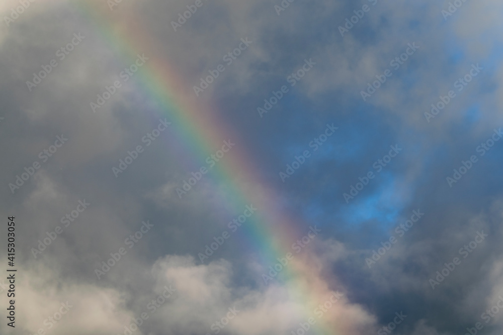 Rainbow in rural area of Guatemala, rain and mountains in open space, natural phenomenon.