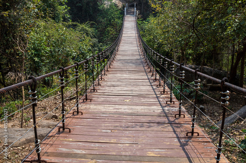 Fototapeta Naklejka Na Ścianę i Meble -  A bridge over a stream in a natural forest.